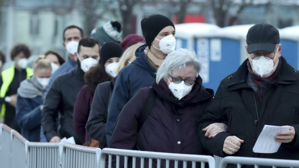 Ľudia s ochrannými rúškami čakajú v rade na prvé hromadné dobrovoľné testovanie na nový druh koronavírusu vo Viedni